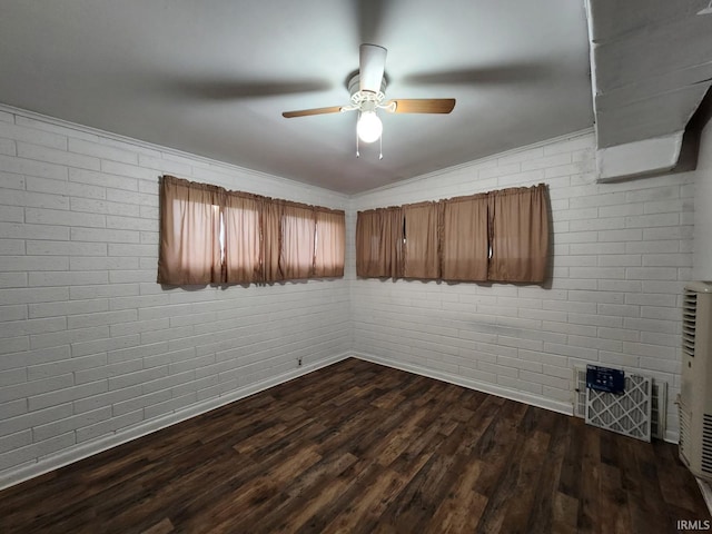 2203 S Valley Ave, Marion, IN 46953 - spare room featuring ceiling fan, dark wood finished floors, baseboards, and brick wall