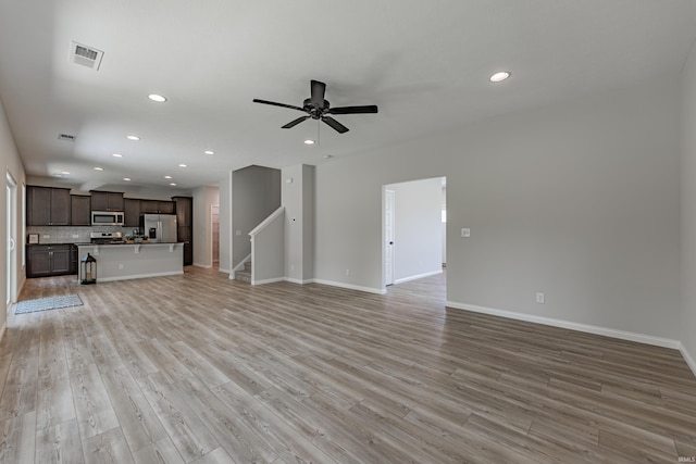 unfurnished living room featuring visible vents, recessed lighting, and a ceiling fan