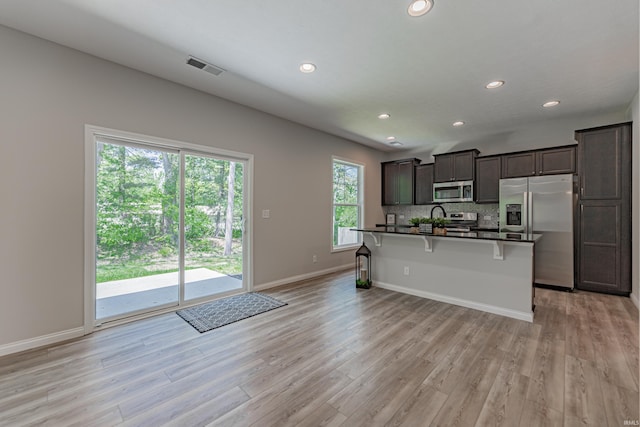 kitchen featuring visible vents, dark countertops, light wood-style floors, recessed lighting, and appliances with stainless steel finishes