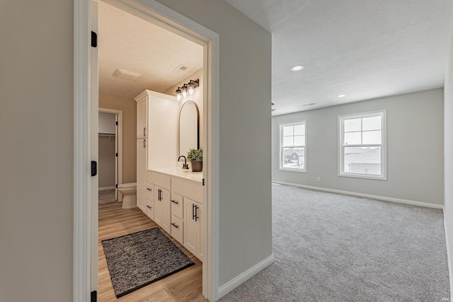 bathroom featuring recessed lighting, baseboards, and vanity