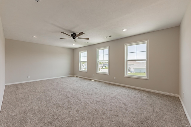 carpeted empty room featuring recessed lighting, ceiling fan, visible vents, and baseboards