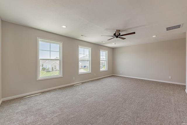 unfurnished room featuring visible vents, a ceiling fan, baseboards, and carpet floors