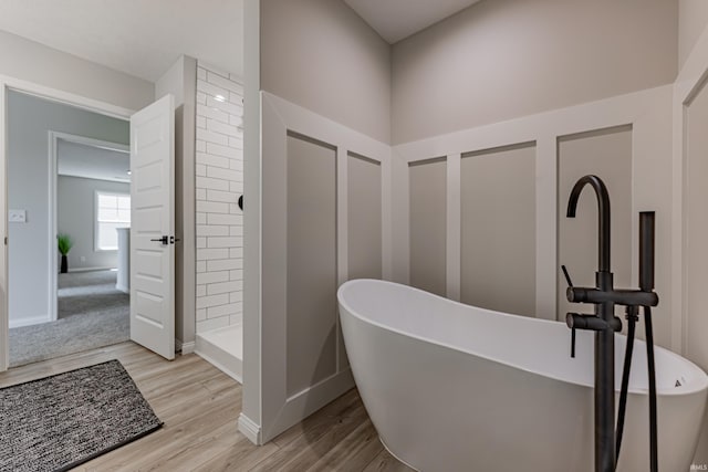 corridor with light wood-style floors and baseboards