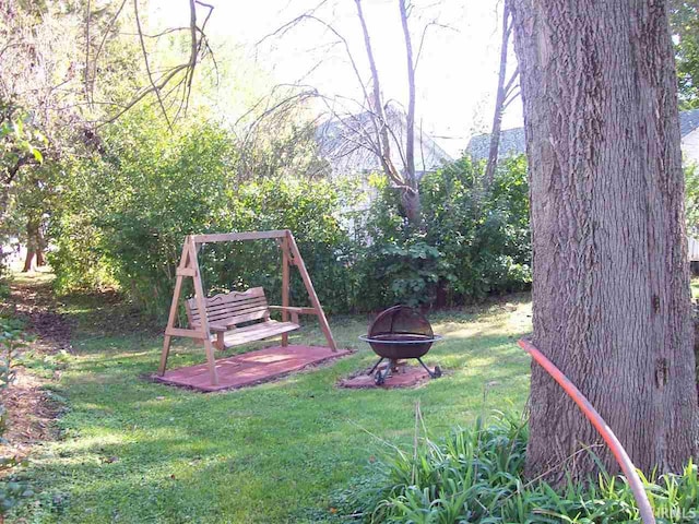 view of yard with an outdoor fire pit