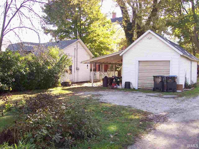 exterior space with driveway, an outbuilding, and a garage
