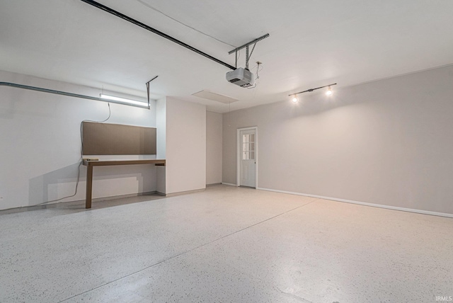 garage featuring baseboards and a garage door opener