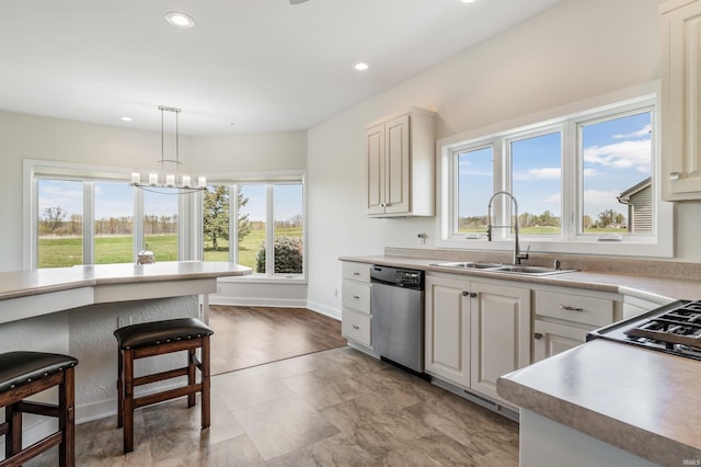 kitchen with an inviting chandelier, a sink, dishwasher, recessed lighting, and decorative light fixtures