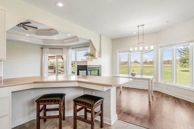 kitchen featuring light countertops, white cabinetry, recessed lighting, and hanging light fixtures