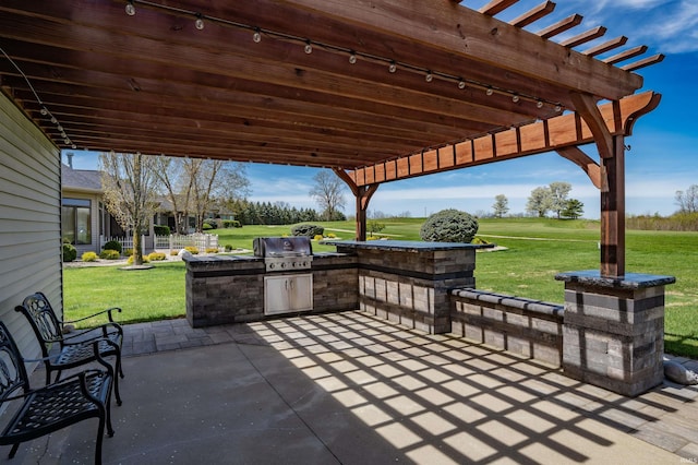 view of patio / terrace with a pergola, a grill, and exterior kitchen