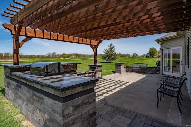 view of patio / terrace featuring grilling area, an outdoor kitchen, and a pergola