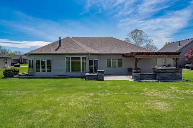 rear view of property featuring a lawn, a pergola, a patio area, and roof with shingles