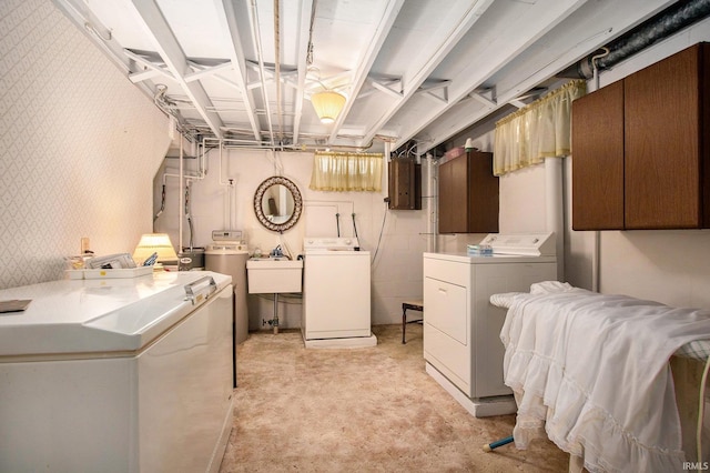 unfinished basement featuring washing machine and clothes dryer, light colored carpet, and a sink