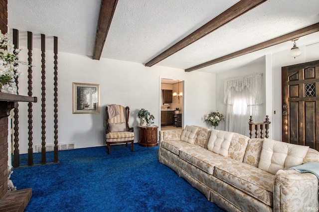 carpeted living room featuring beam ceiling, a notable chandelier, a textured ceiling, and visible vents