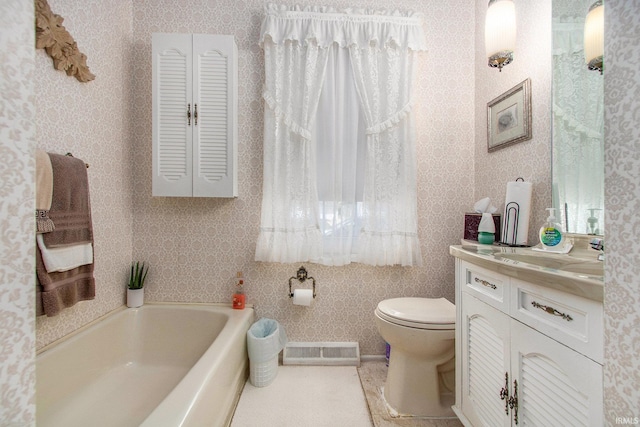 bathroom featuring toilet, visible vents, a bath, and vanity