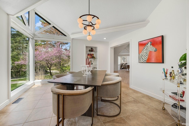 dining room with visible vents, lofted ceiling, and a healthy amount of sunlight
