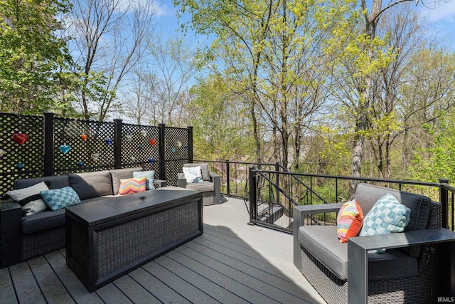 wooden terrace with an outdoor living space