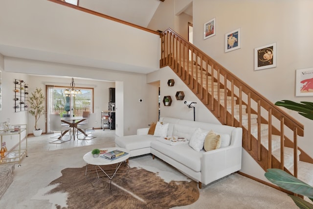 living room with stairs, a high ceiling, a notable chandelier, and carpet