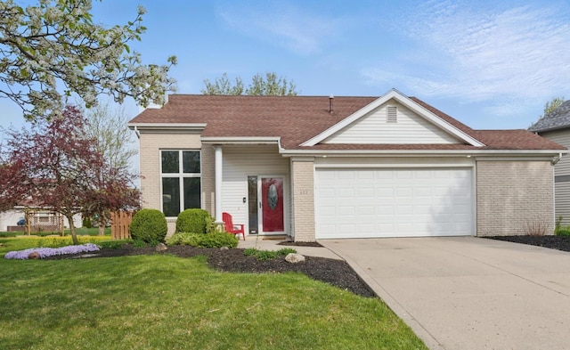 view of front of home with roof with shingles, an attached garage, brick siding, a front yard, and concrete driveway