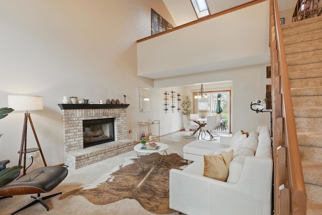 carpeted living area with a high ceiling, a notable chandelier, a brick fireplace, baseboards, and stairway