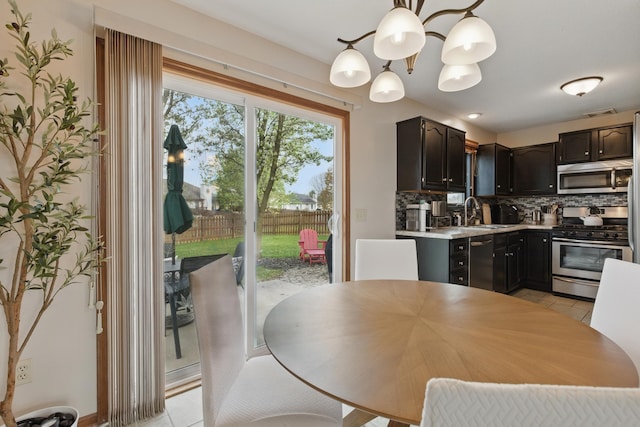 dining area with a chandelier and light tile patterned flooring