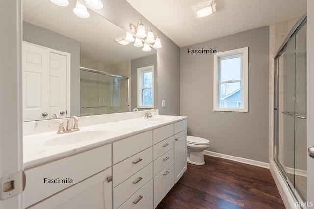full bathroom with double vanity, a sink, and a shower stall