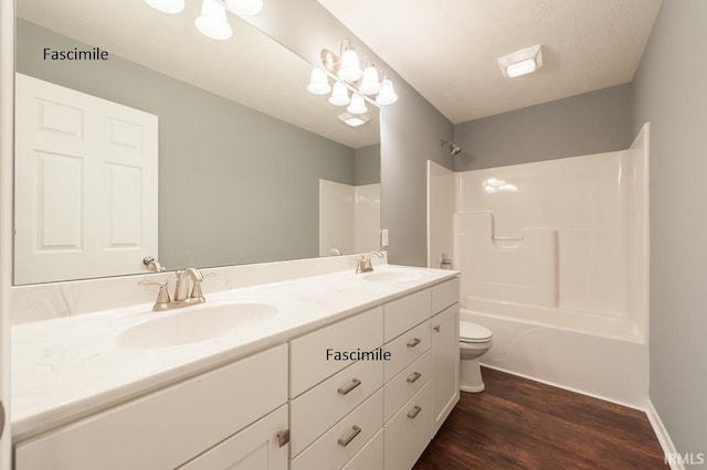 916 S Lantern Ln, Ellettsville, IN 47429 - bathroom featuring wood finished floors, toilet, double vanity, shower / bath combination, and baseboards