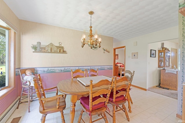 dining room with an inviting chandelier, wainscoting, baseboards, light floors, and wallpapered walls