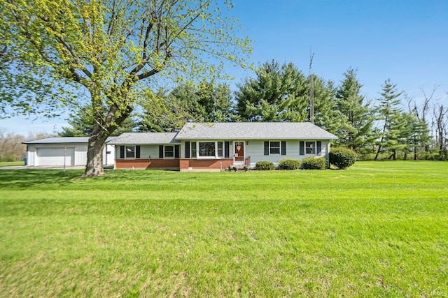 single story home featuring brick siding, an outdoor structure, and a front lawn
