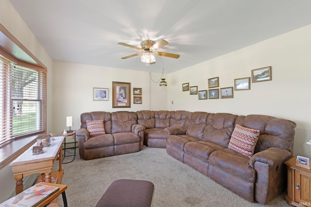 living area featuring carpet flooring and ceiling fan