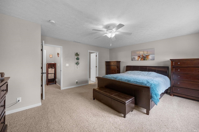 bedroom with carpet floors, a textured ceiling, baseboards, and a ceiling fan