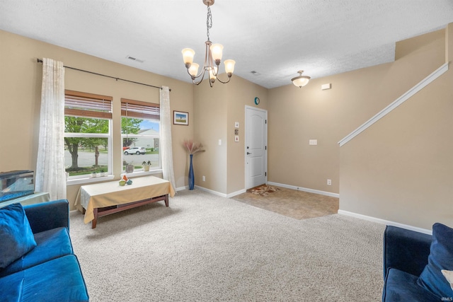 living area featuring light colored carpet, a textured ceiling, a chandelier, baseboards, and visible vents