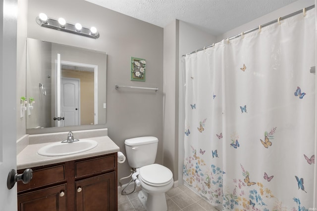 bathroom featuring tile patterned flooring, vanity, toilet, a textured ceiling, and curtained shower