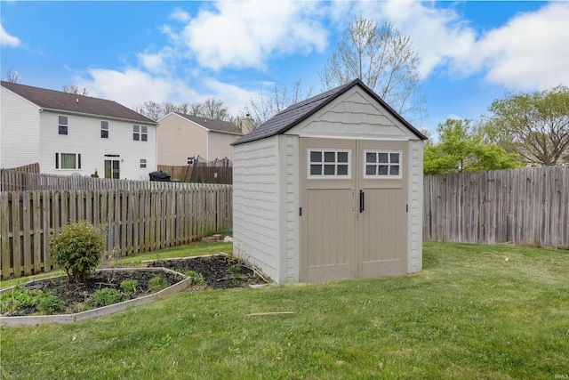 view of shed featuring a fenced backyard
