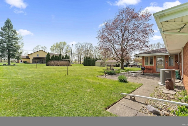 view of yard featuring a patio and central AC