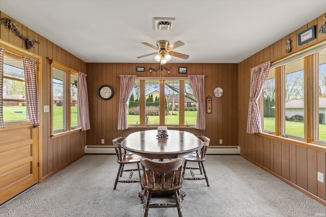 dining area with a ceiling fan, a wealth of natural light, and light carpet