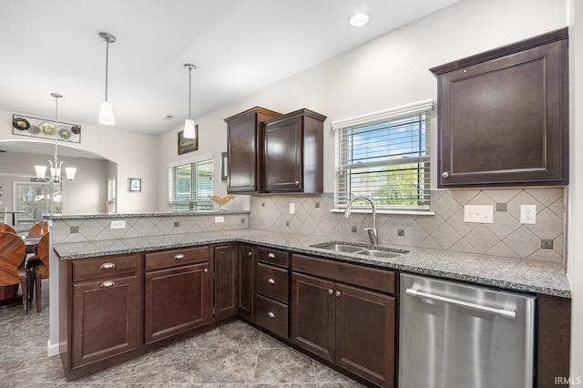 kitchen with dark brown cabinets, a sink, a chandelier, a peninsula, and stainless steel dishwasher