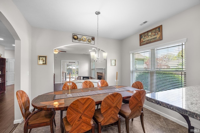 dining area with arched walkways, baseboards, and visible vents