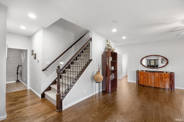 stairway featuring recessed lighting, baseboards, and wood finished floors