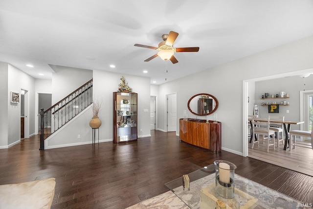 living room featuring a ceiling fan, recessed lighting, wood finished floors, and stairway