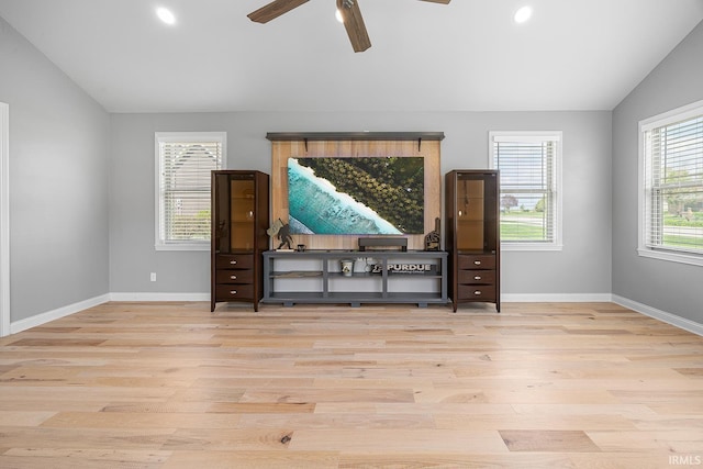 unfurnished room with baseboards, a ceiling fan, wood finished floors, and vaulted ceiling