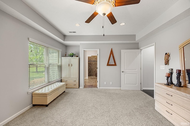 bedroom with visible vents, baseboards, a ceiling fan, carpet, and ensuite bath