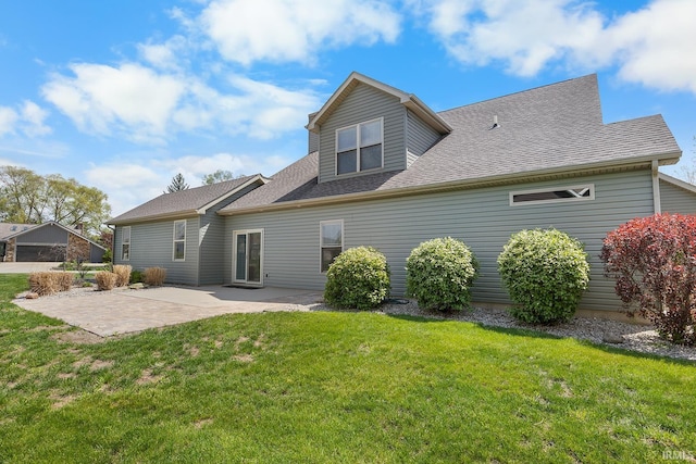 back of property featuring a lawn, a patio area, and roof with shingles