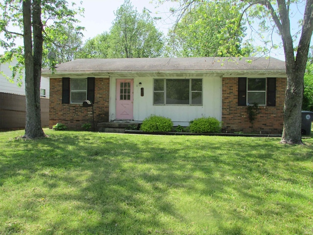 ranch-style house with board and batten siding, brick siding, and a front lawn
