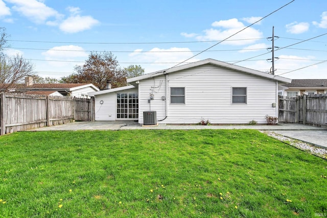 back of property featuring a fenced backyard, a patio area, and a yard