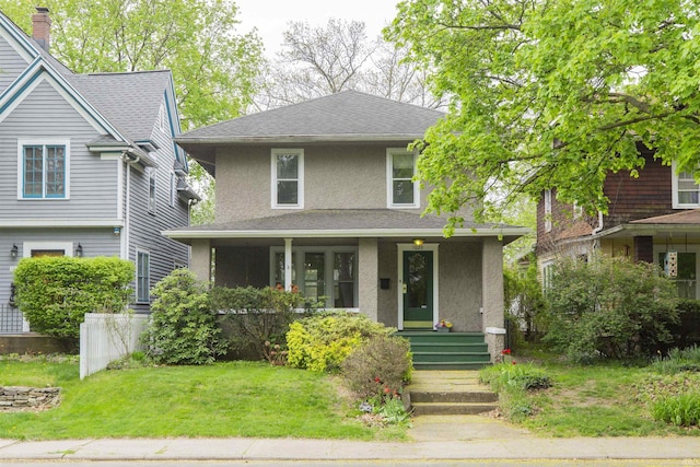 traditional style home featuring a shingled roof, a front lawn, stucco siding, a porch, and a chimney