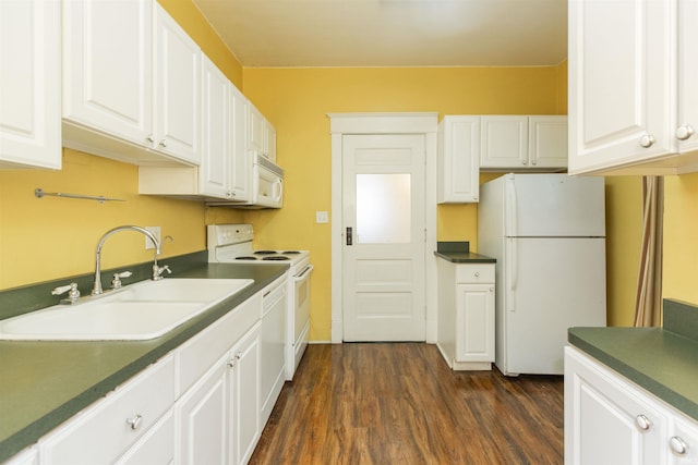 kitchen with a sink, dark countertops, white cabinets, and white appliances