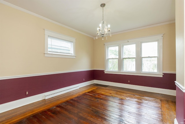 empty room featuring baseboards, crown molding, a chandelier, and hardwood / wood-style flooring