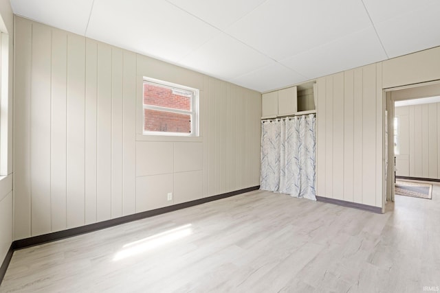 unfurnished room featuring light wood-style floors and baseboards