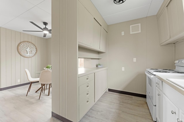 kitchen featuring ceiling fan, white electric range, light countertops, baseboards, and light wood finished floors