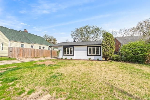 exterior space with fence and a front yard